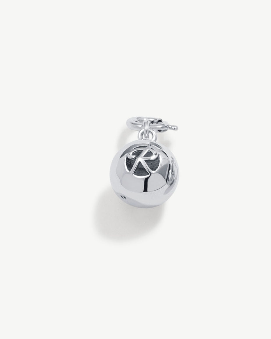 a silver bell with a chain on a white background