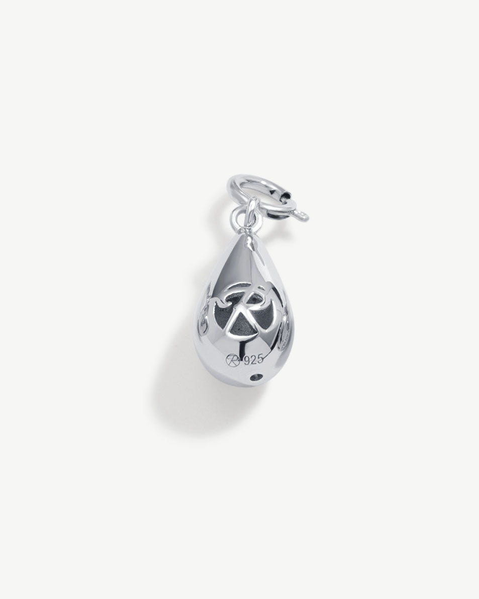 a silver charm with a peace sign on it