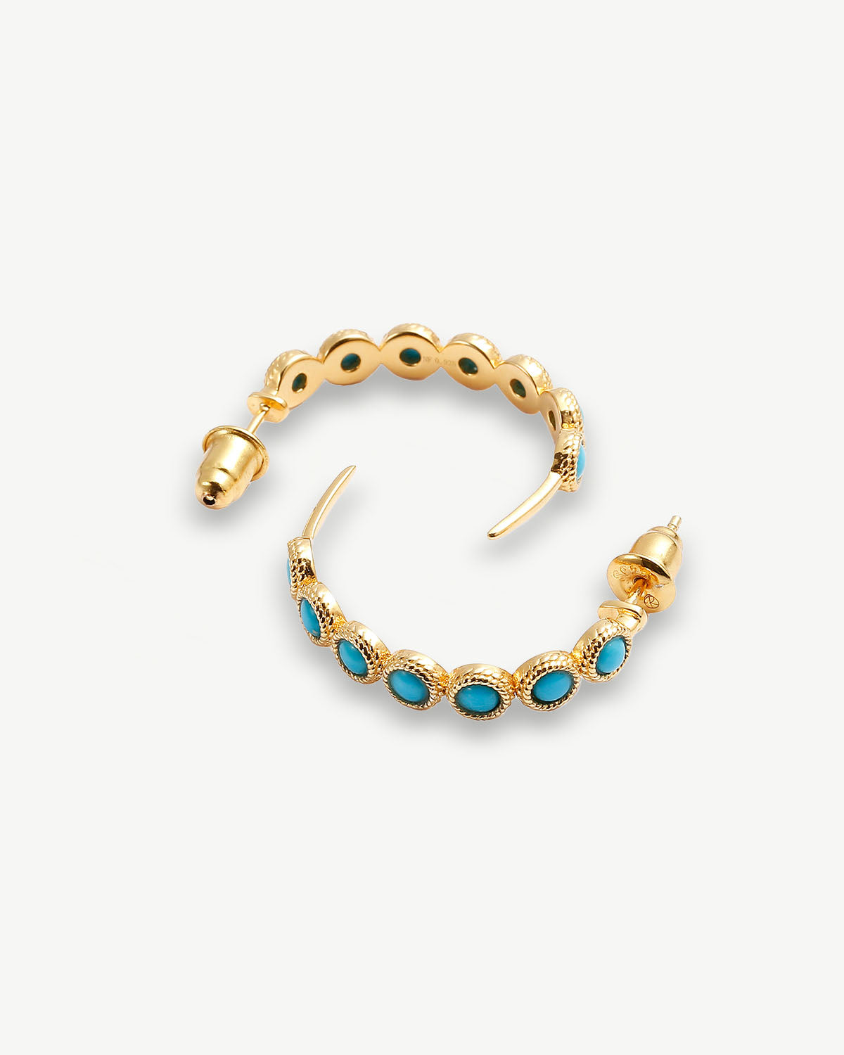 a pair of gold hoop earrings with turquoise stones