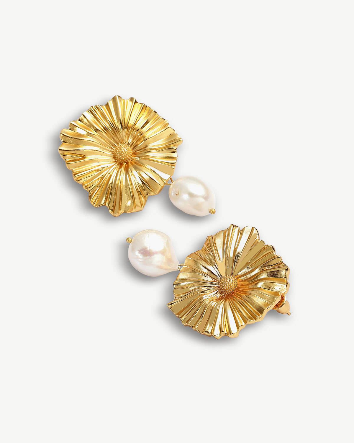 a pair of gold earrings with pearls