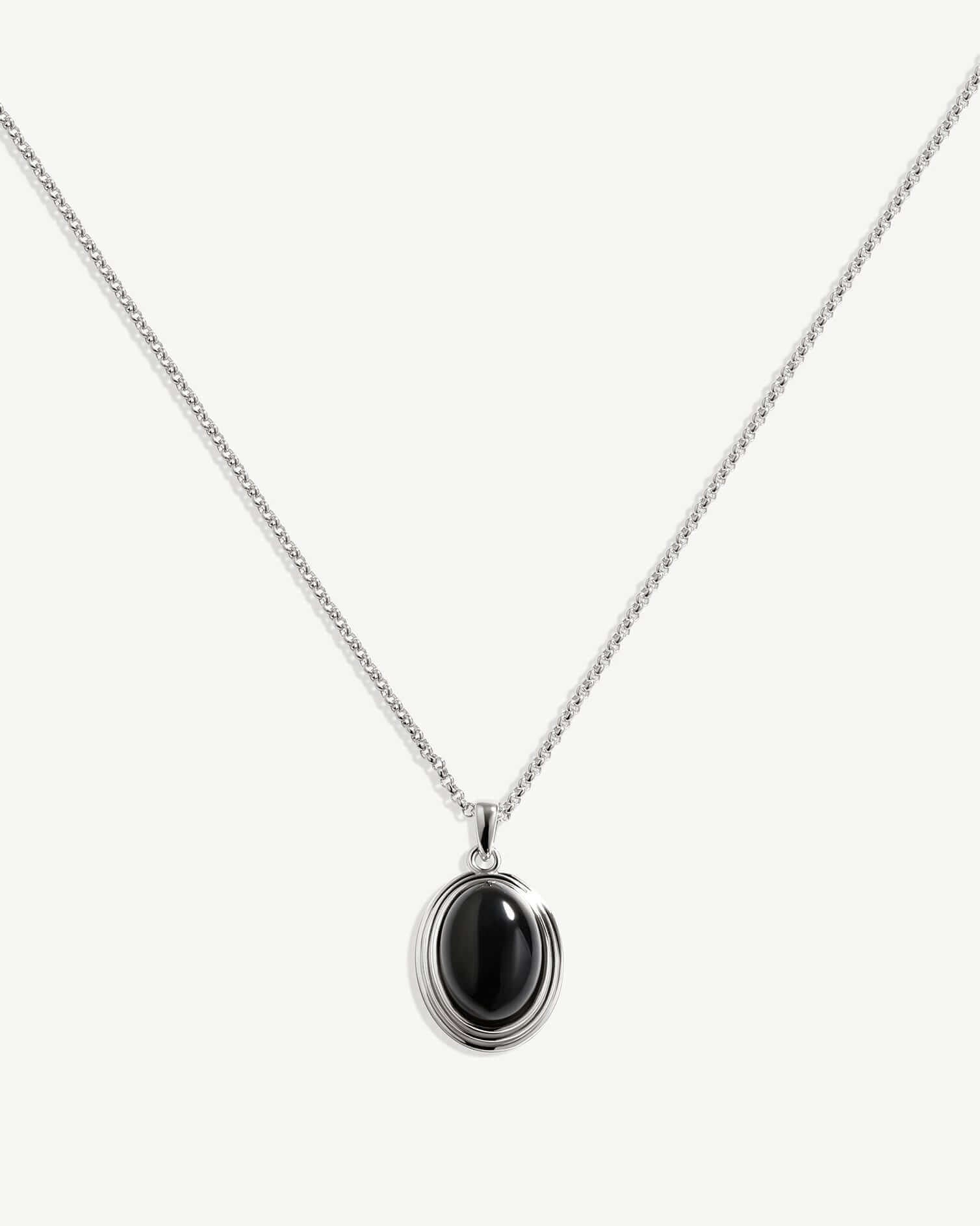 a necklace with a black stone on it