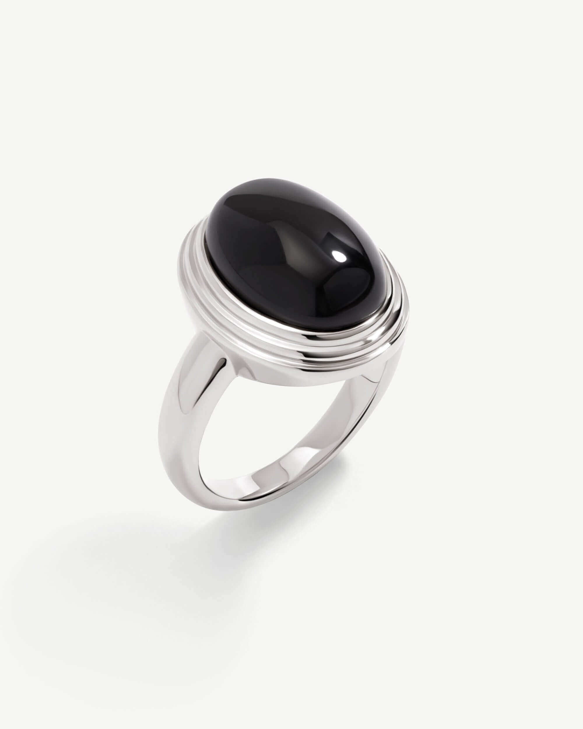 a silver ring with a black stone on it