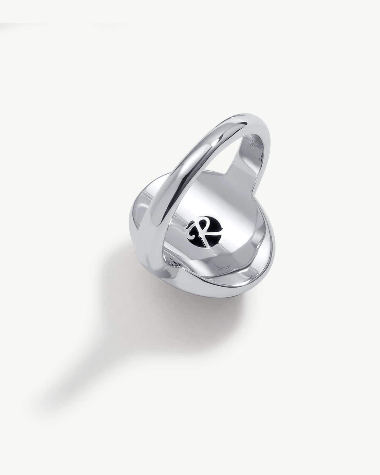 a silver ring with a heart on it