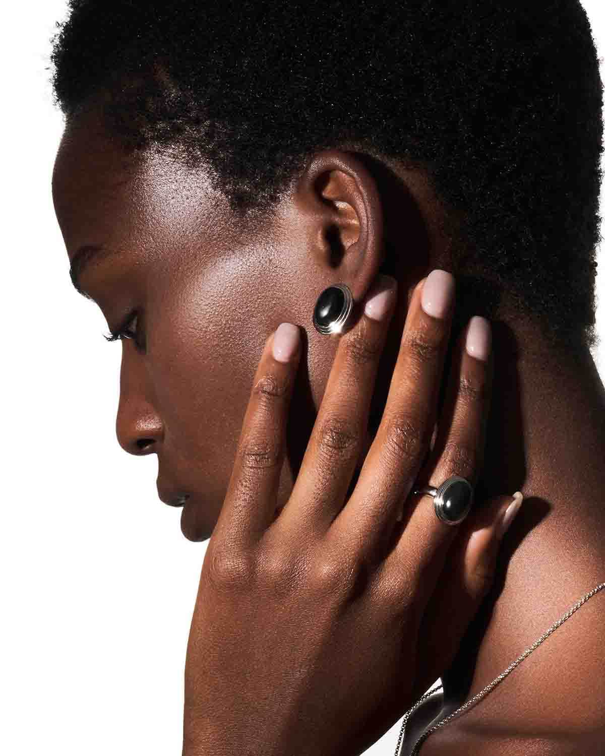 a woman with her hand on her ear