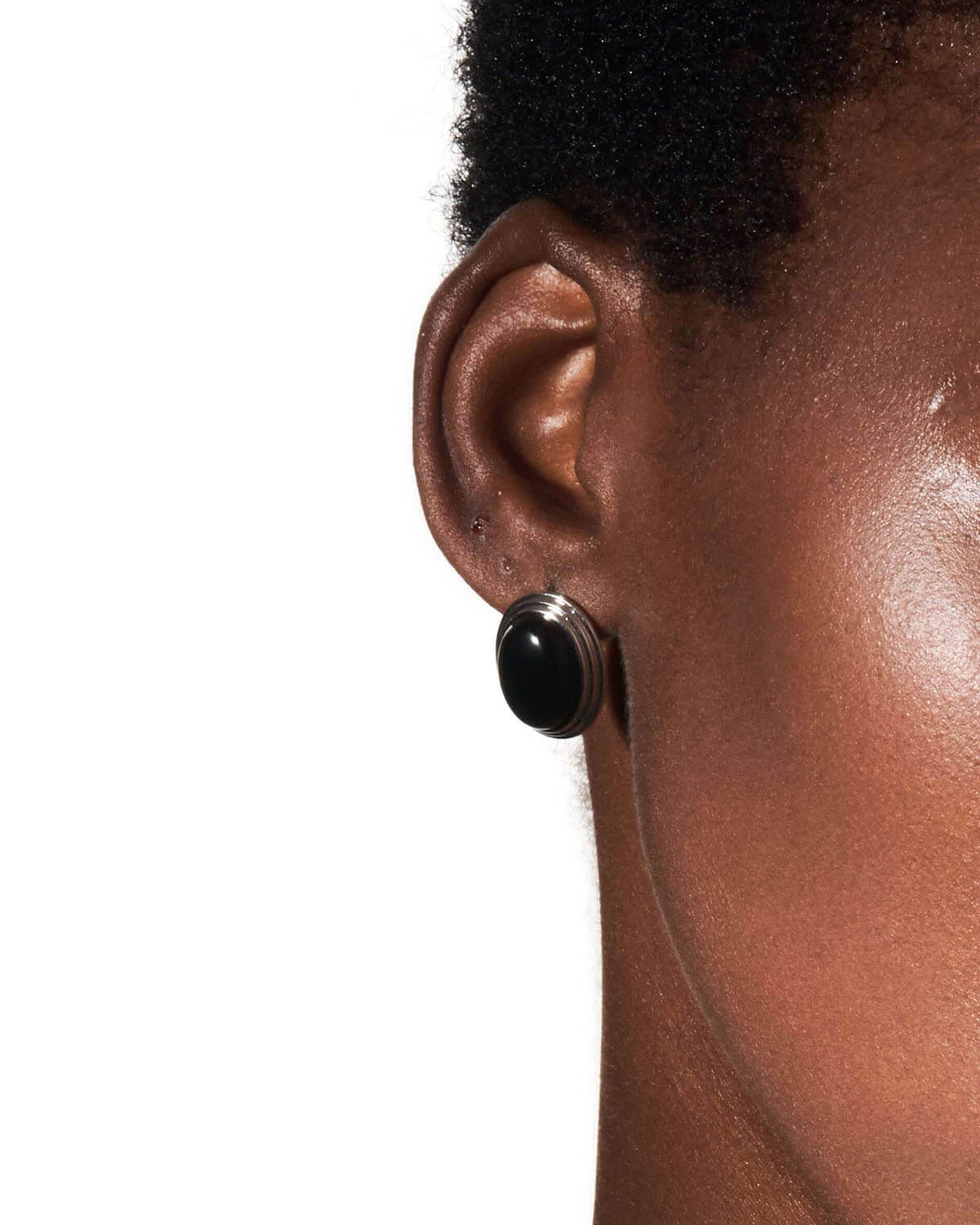 a close up of a person wearing a pair of earrings