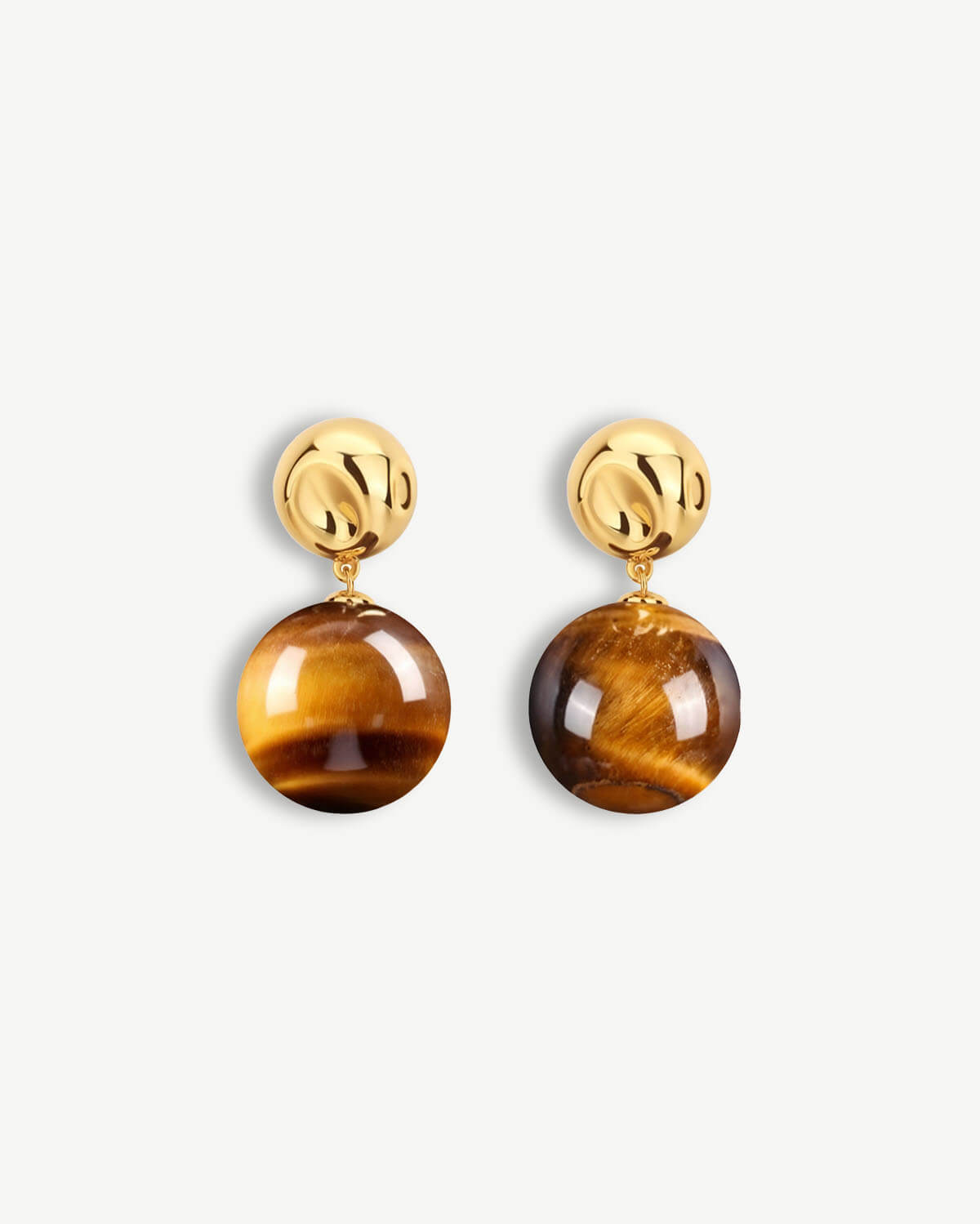 a pair of tiger's eye earrings on a white background