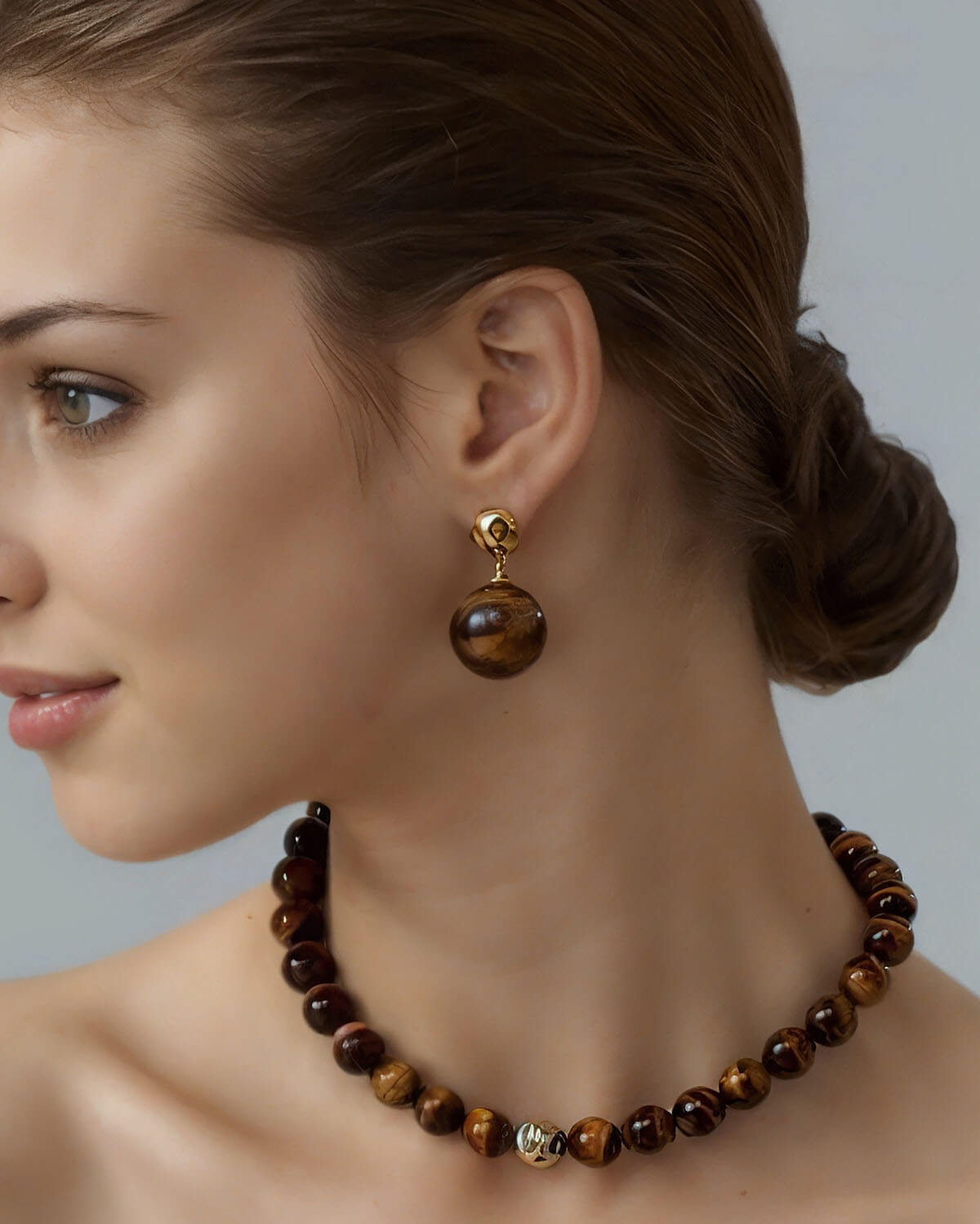 a woman wearing a brown necklace and earrings