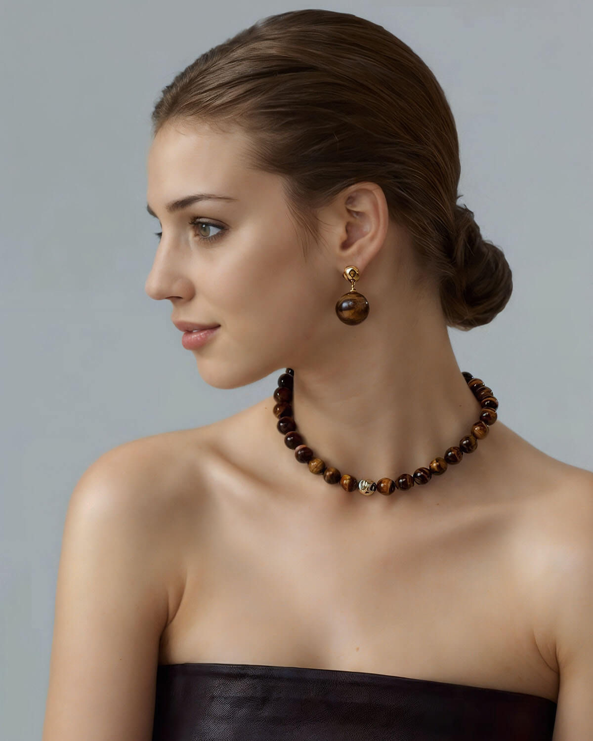 a woman wearing a brown dress and a necklace