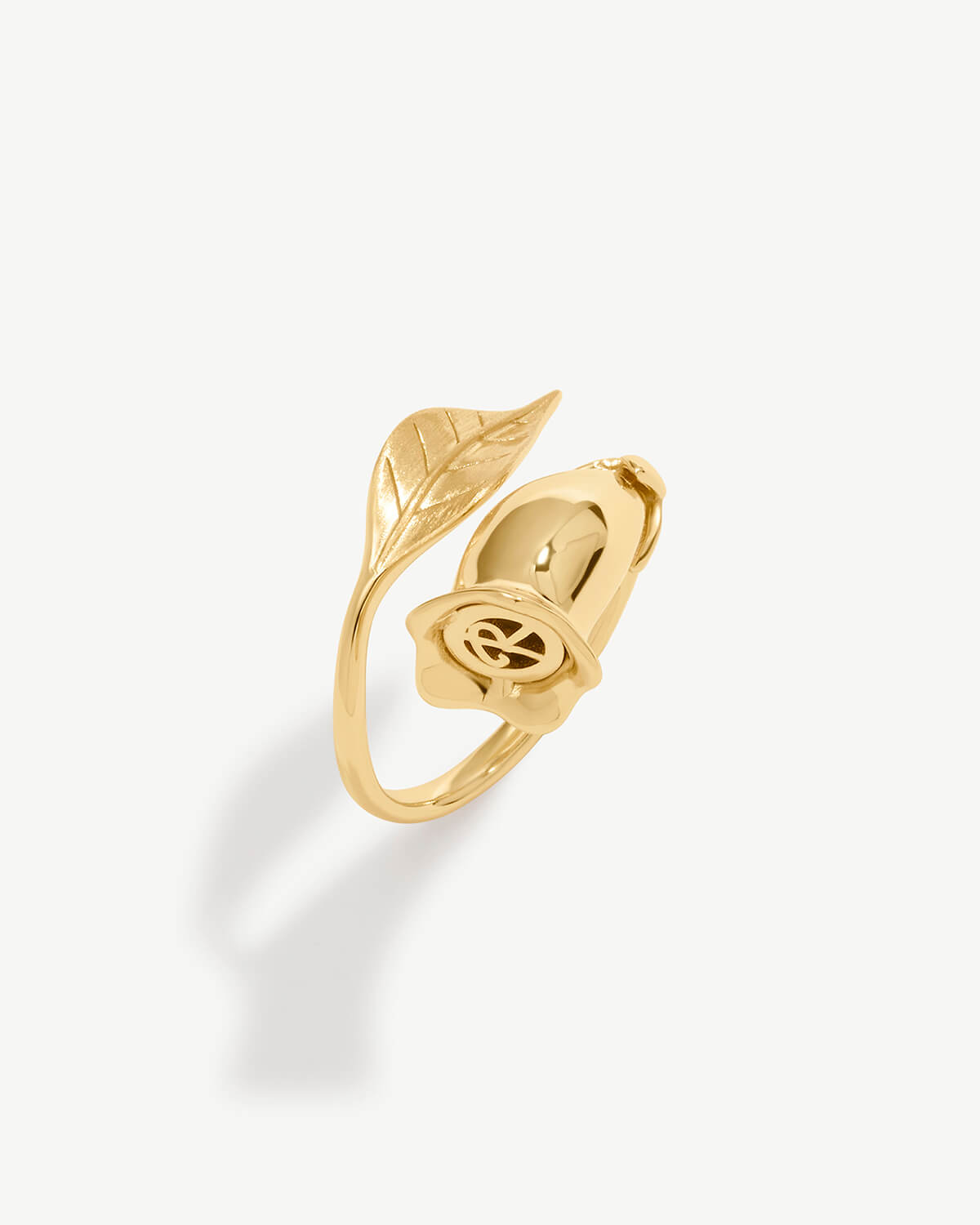 a gold ring with leaves on it