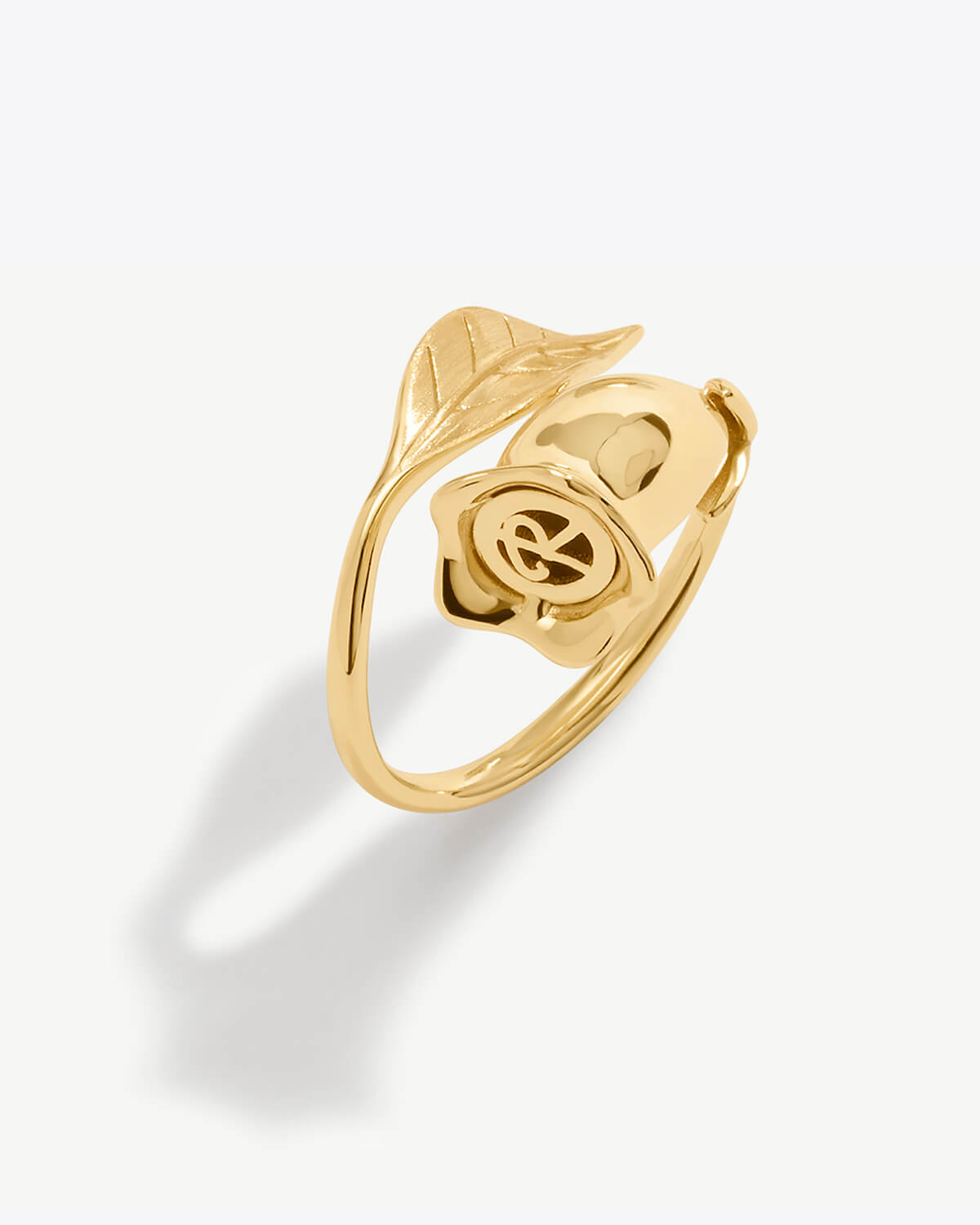 a gold ring with a leaf on it