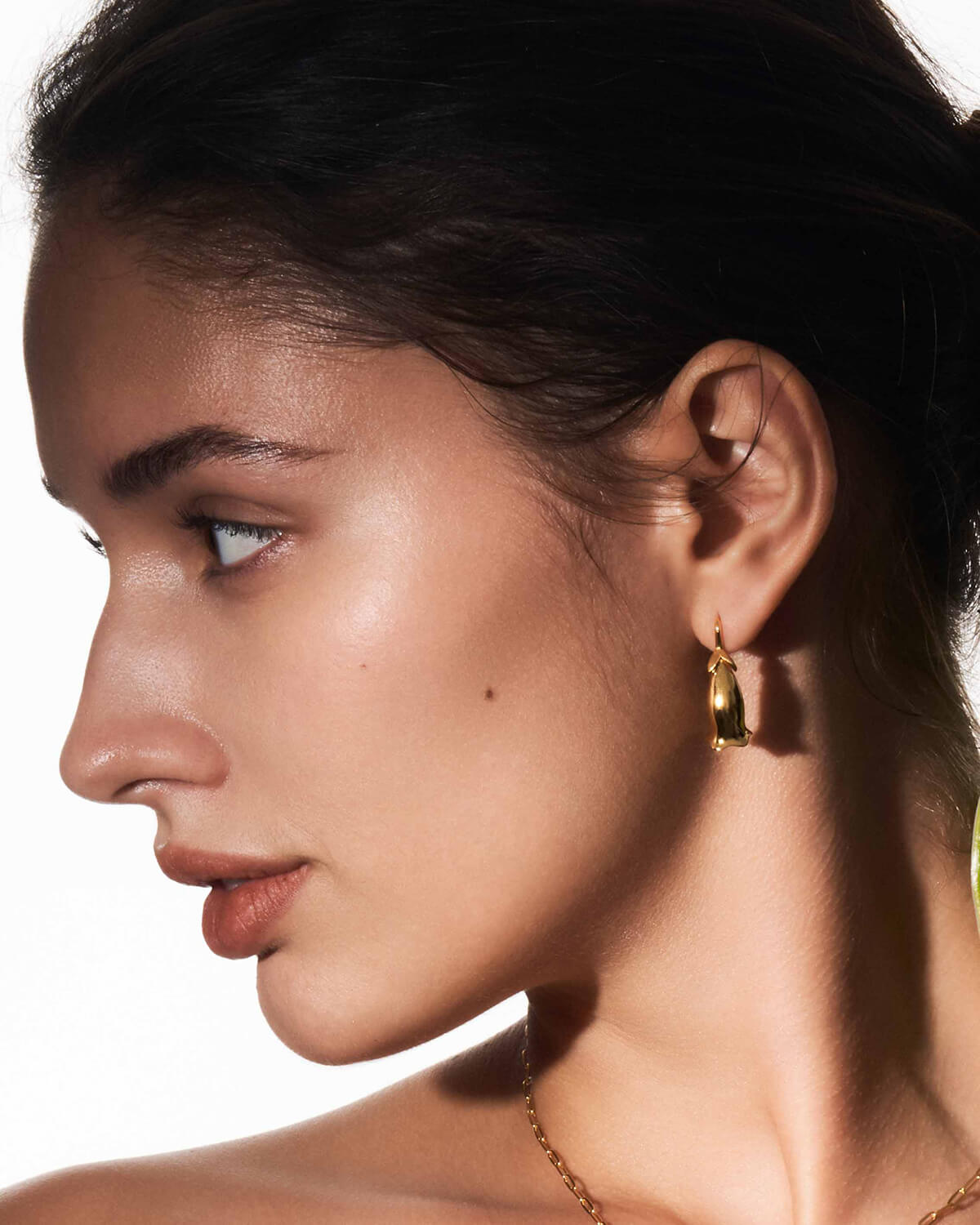 a close up of a person wearing a pair of earrings