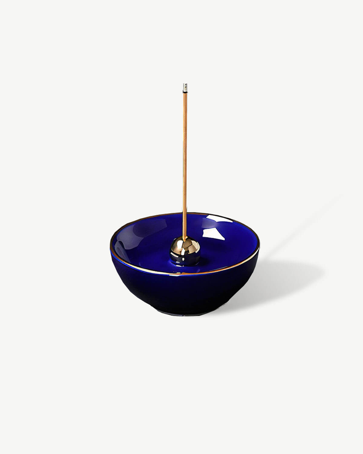 a blue bowl with a wooden stick sticking out of it