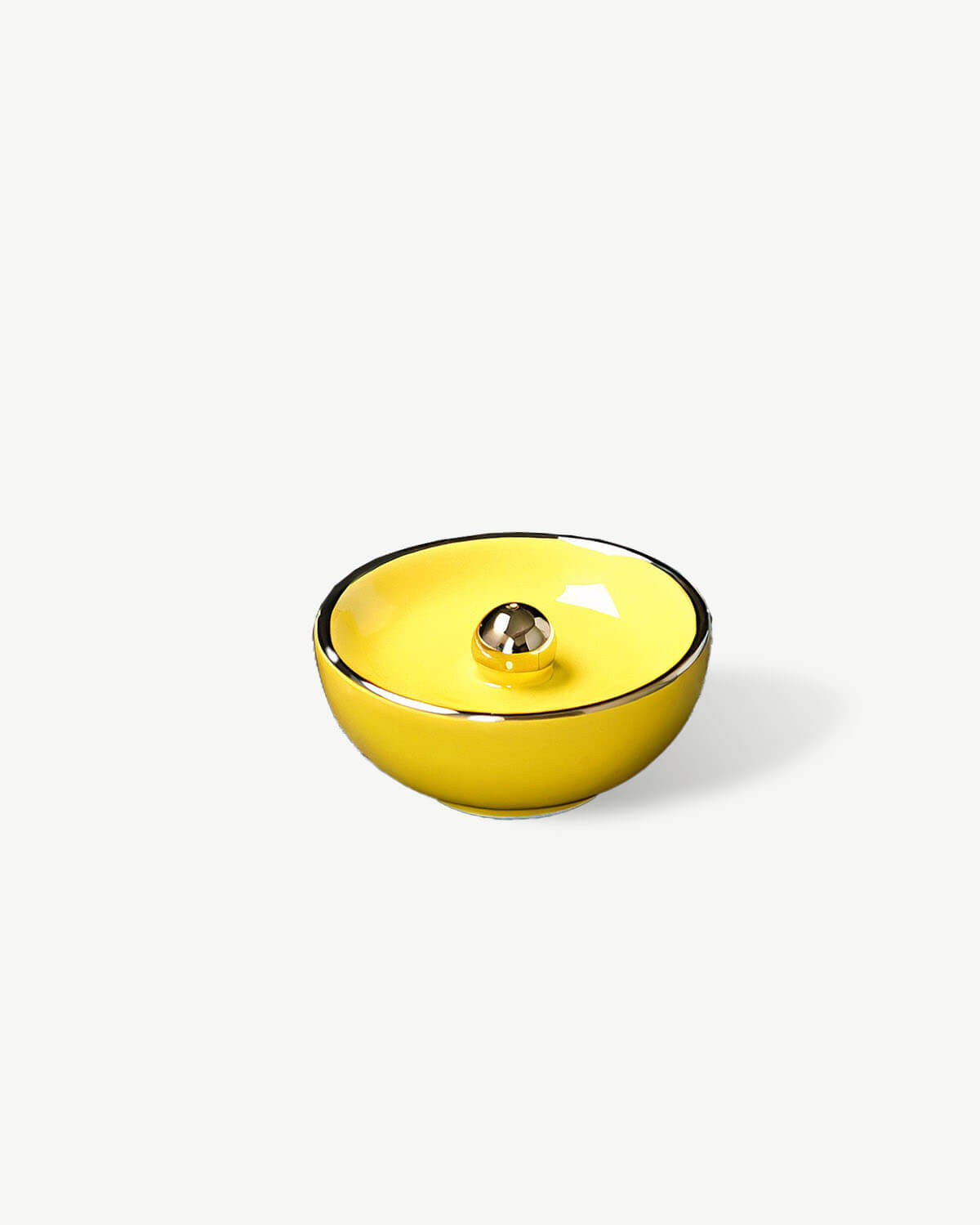 a yellow bowl sitting on top of a white table