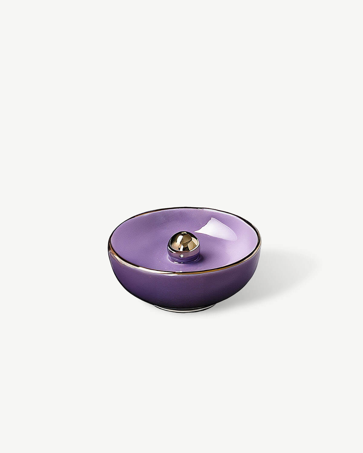 a purple bowl sitting on top of a white table