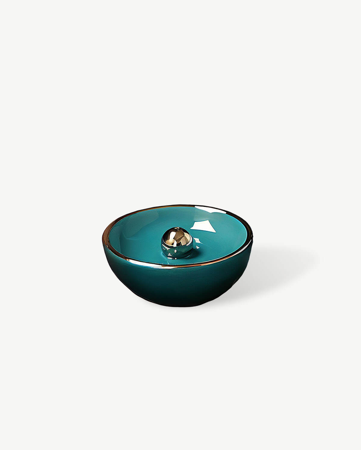 a teal bowl with a gold rim