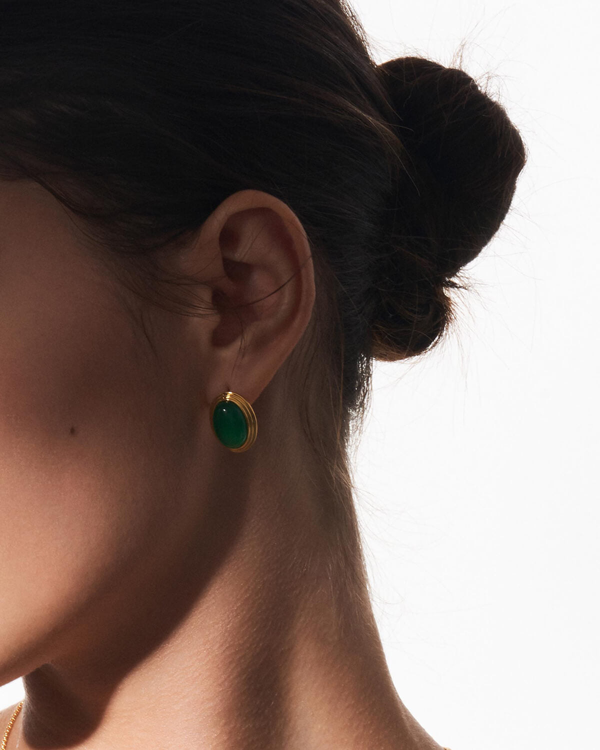 a close up of a person wearing a pair of earrings