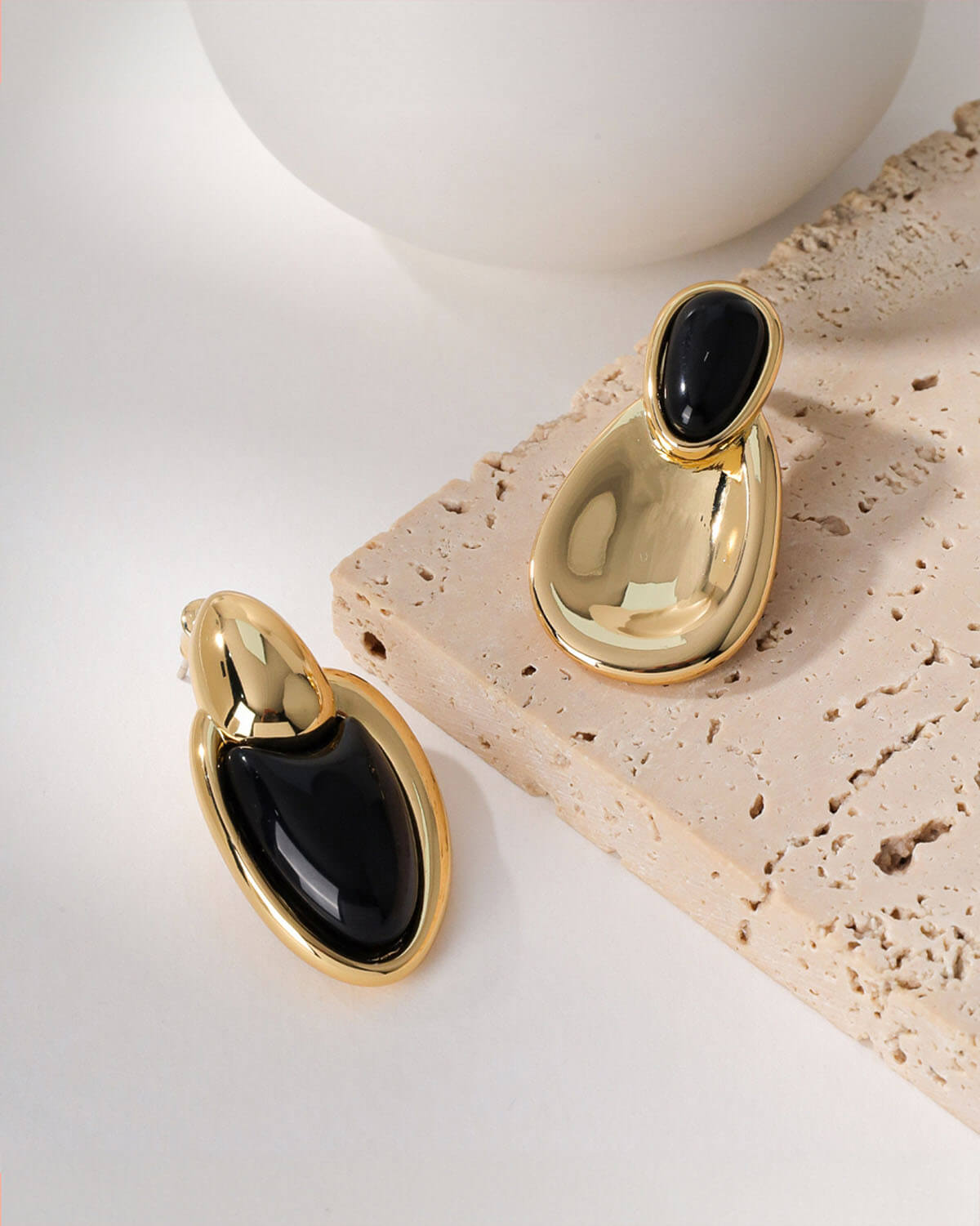 a pair of earrings sitting on top of a table