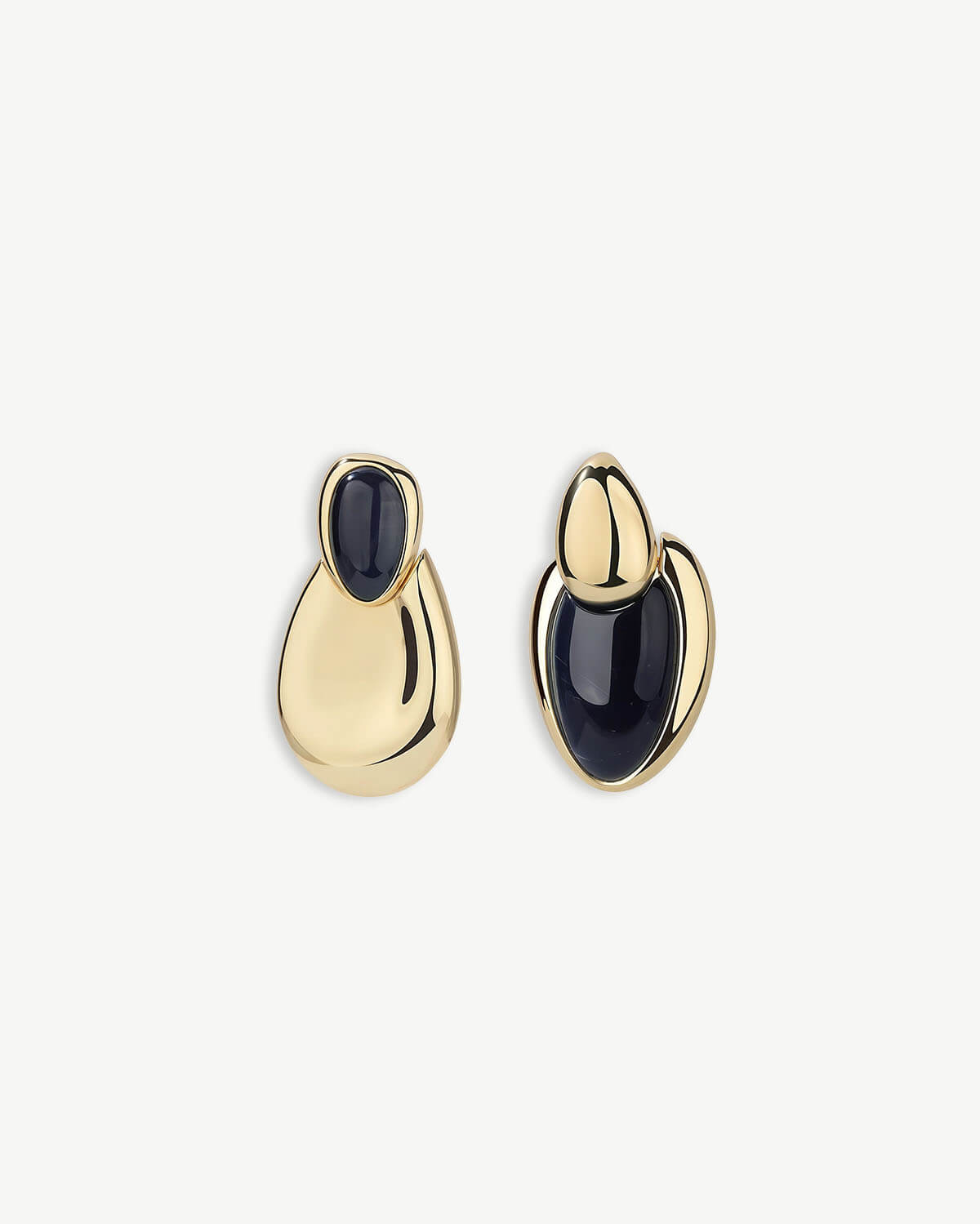 a pair of gold and black earrings