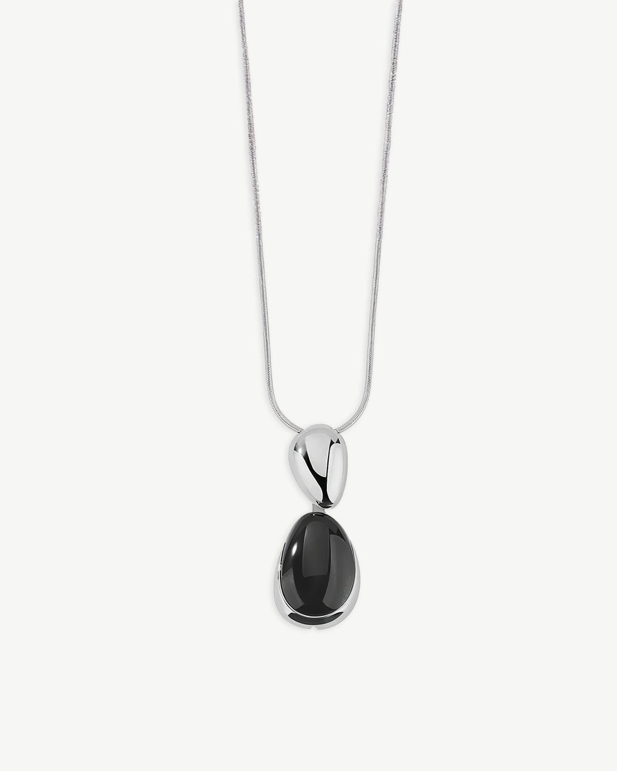 a necklace with a black stone hanging from it