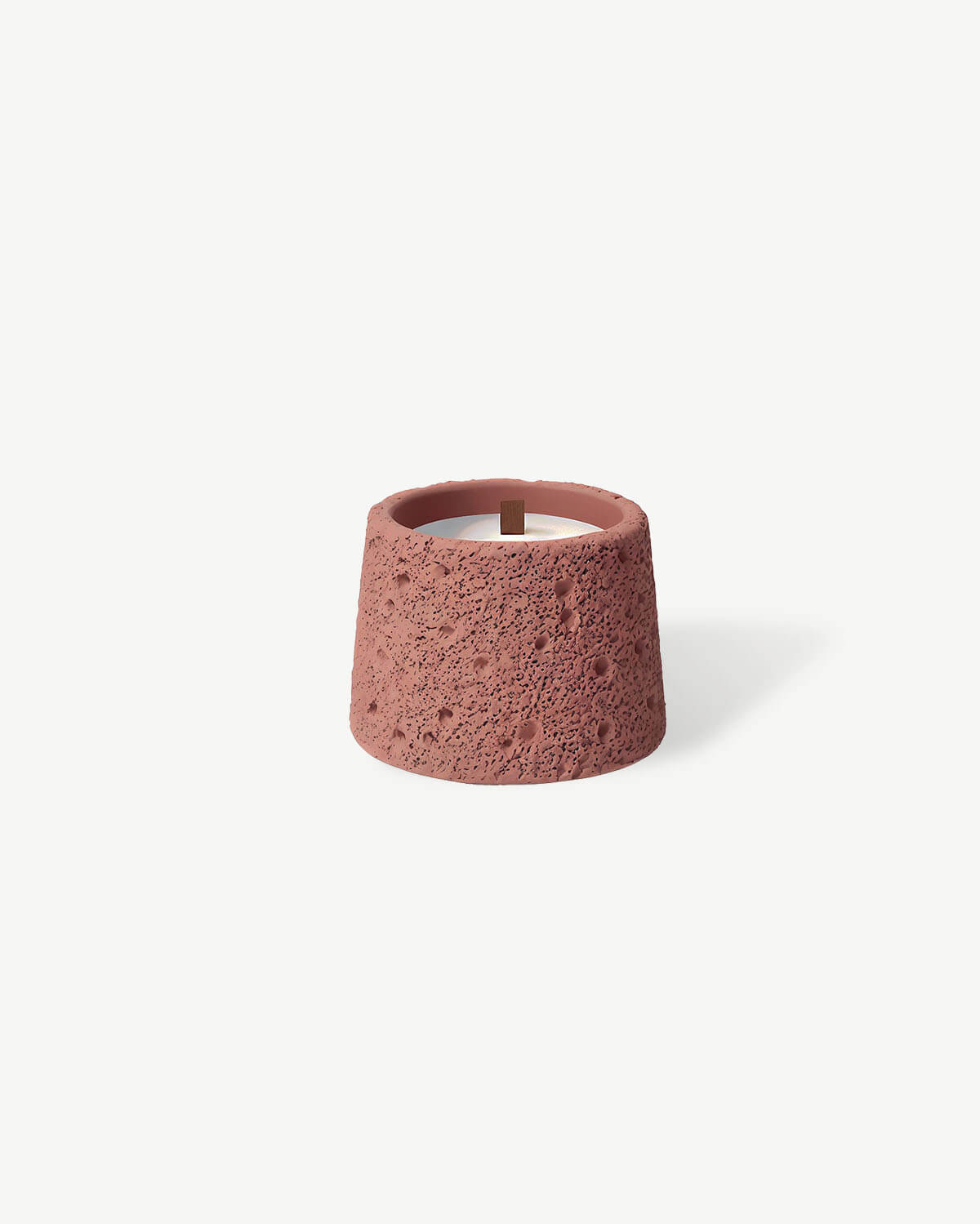 a small pink candle holder on a white background