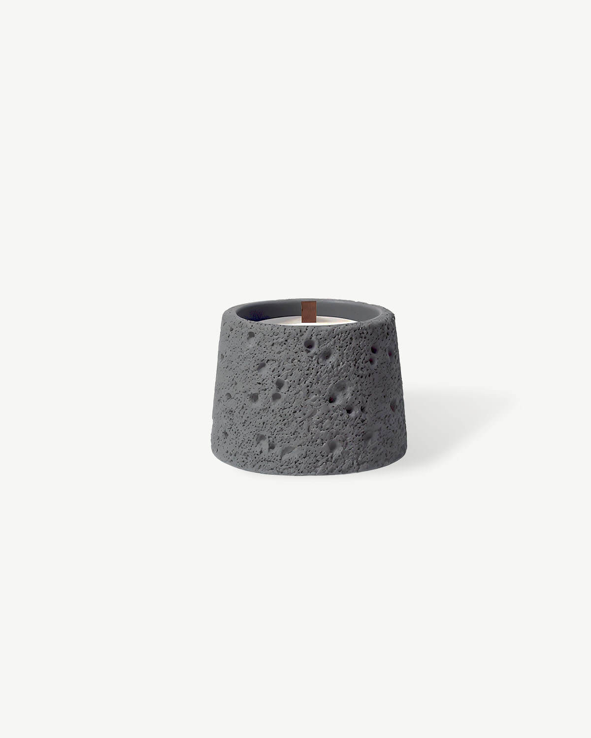 a concrete candle holder on a white background