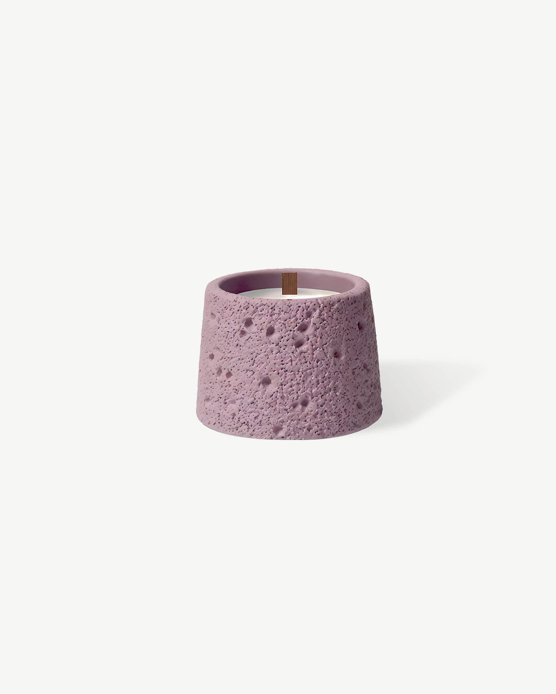 a small purple candle holder on a white background