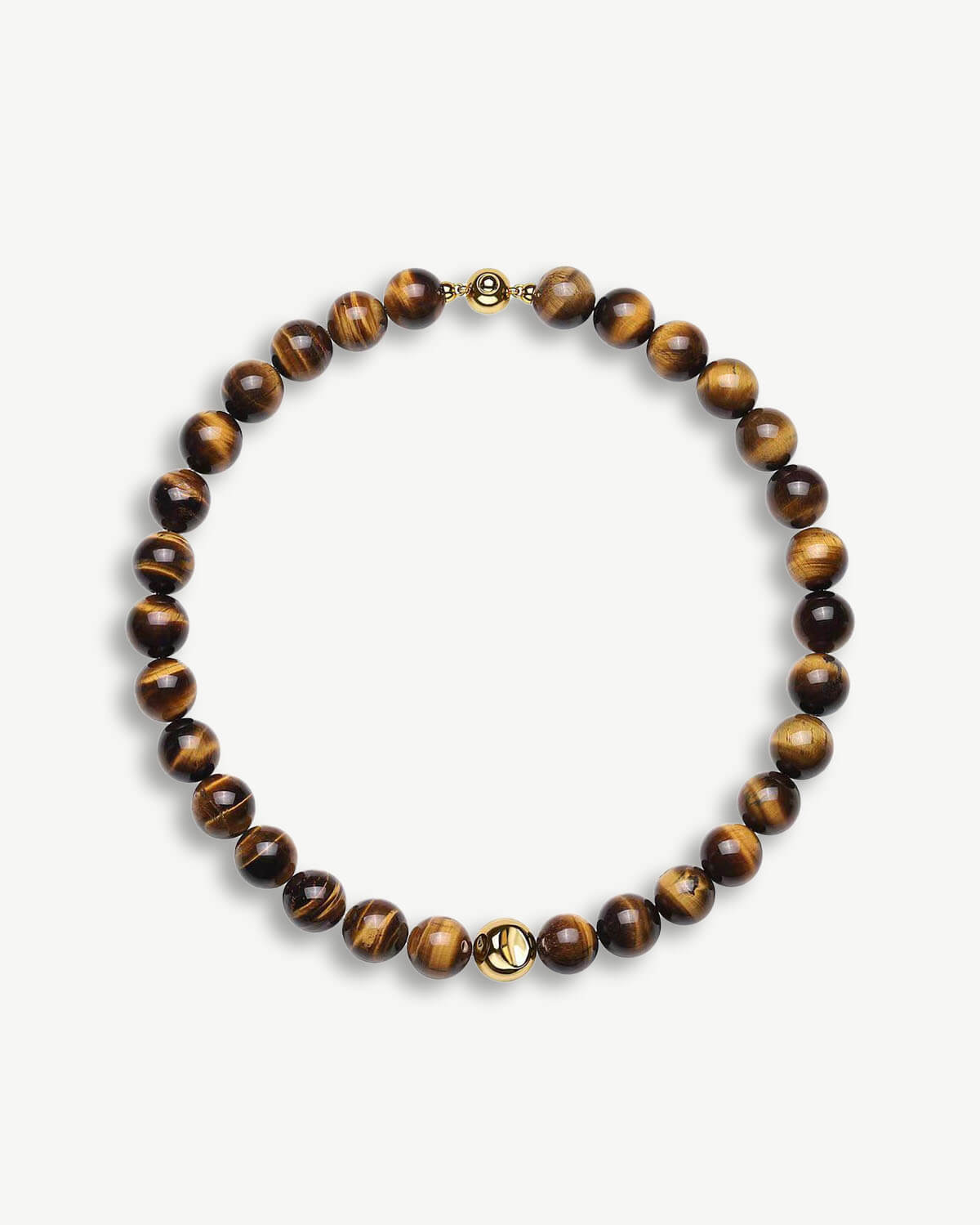 a tiger's eye beaded bracelet with a gold charm