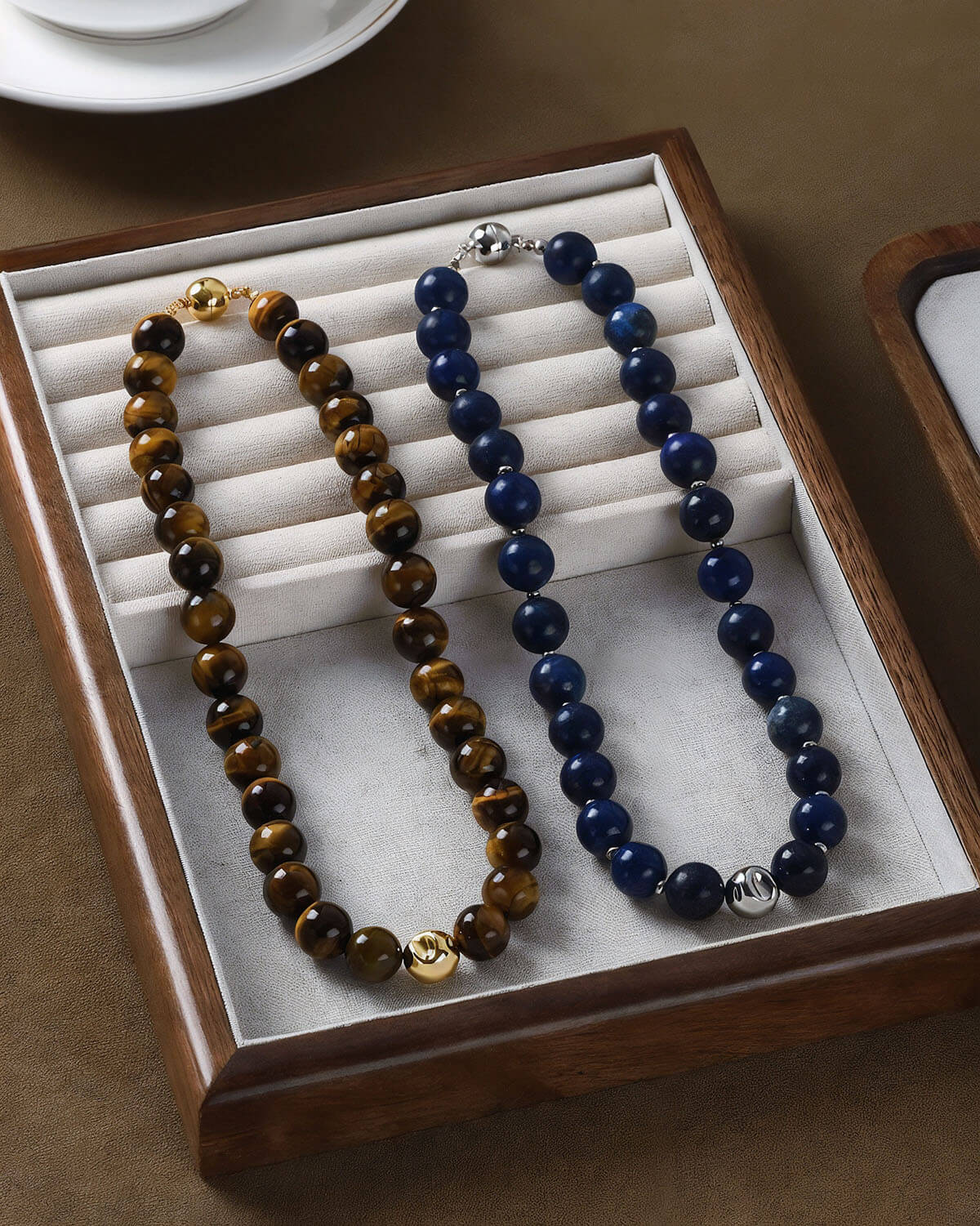 two necklaces in a box on a table