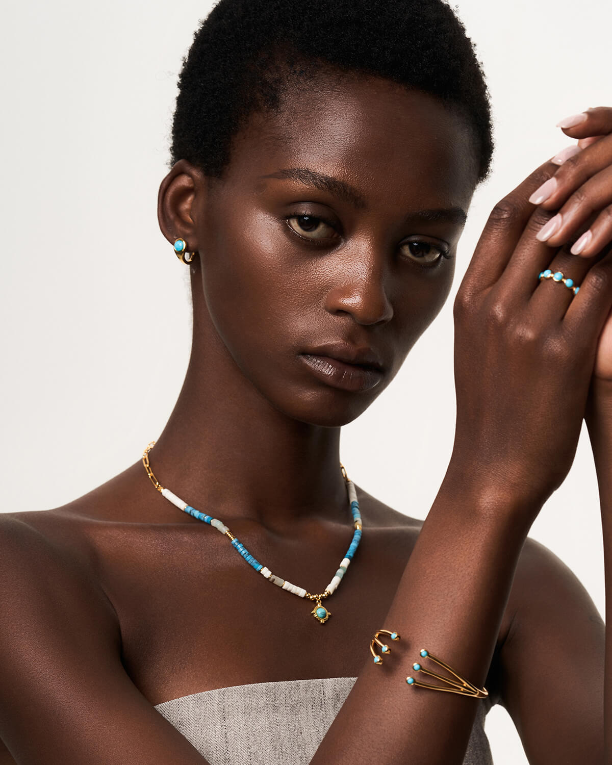 a woman wearing a necklace and bracelet with beads