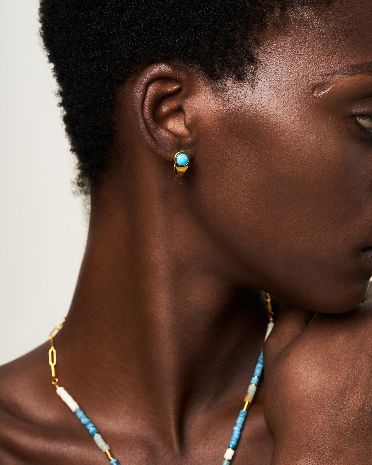 a close up of a woman wearing a necklace