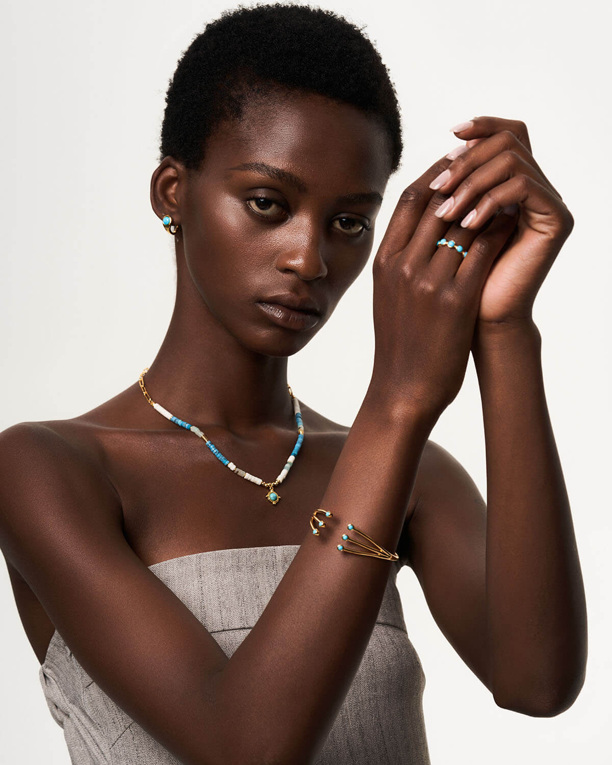 a young woman wearing a necklace and bracelet