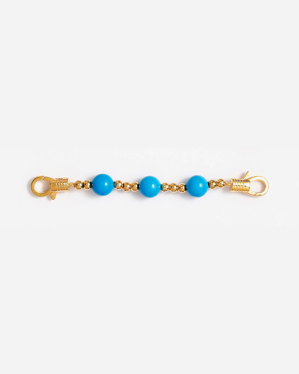 a pair of blue beads on a gold chain