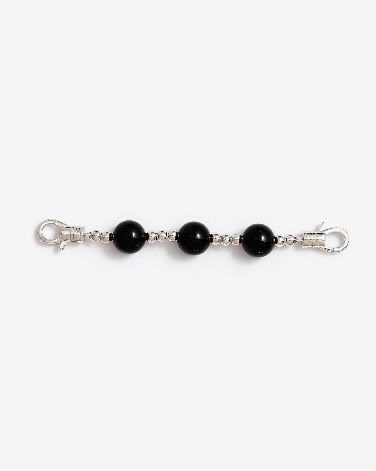 a pair of black beads on a silver chain