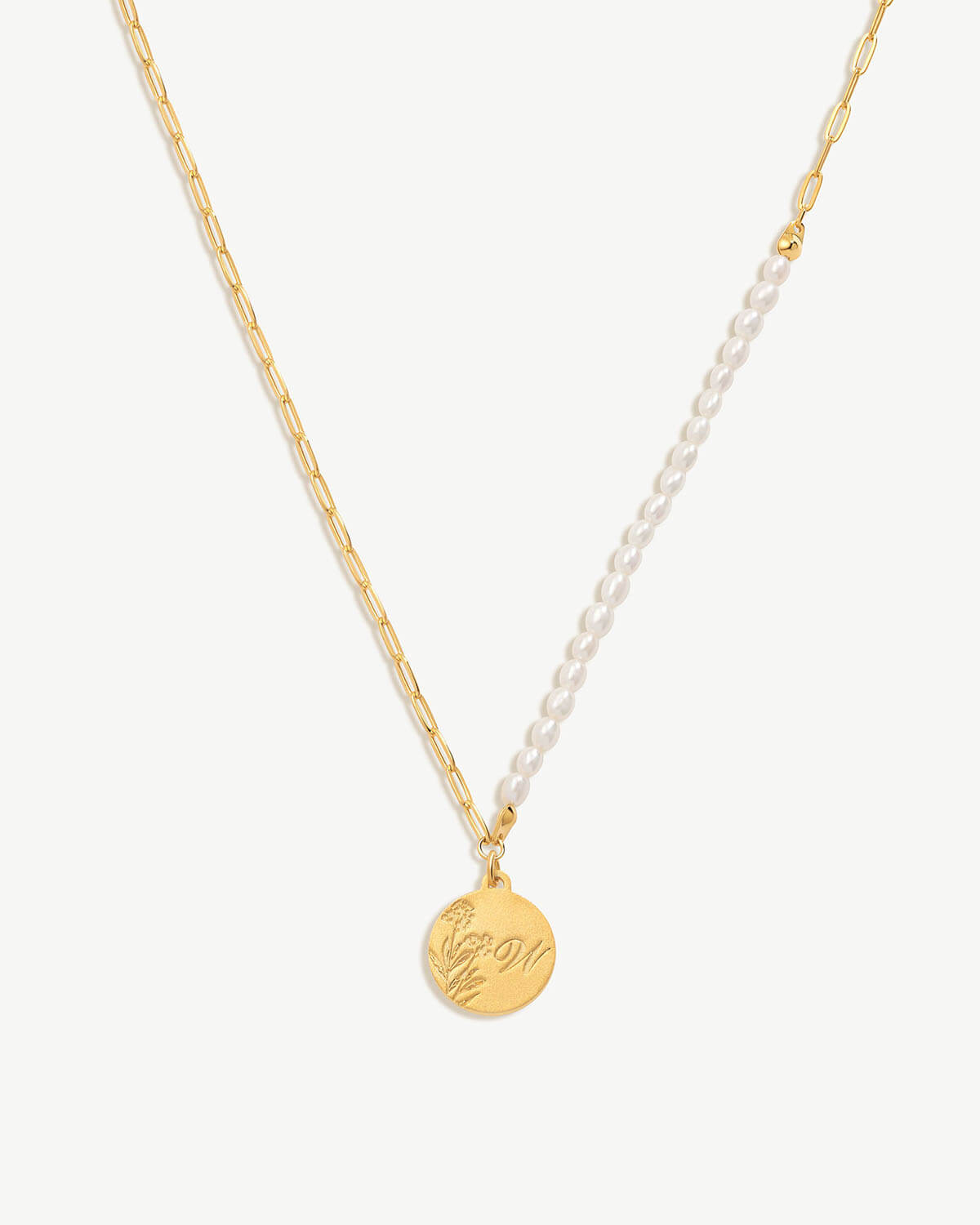 a necklace with a gold disc on a chain