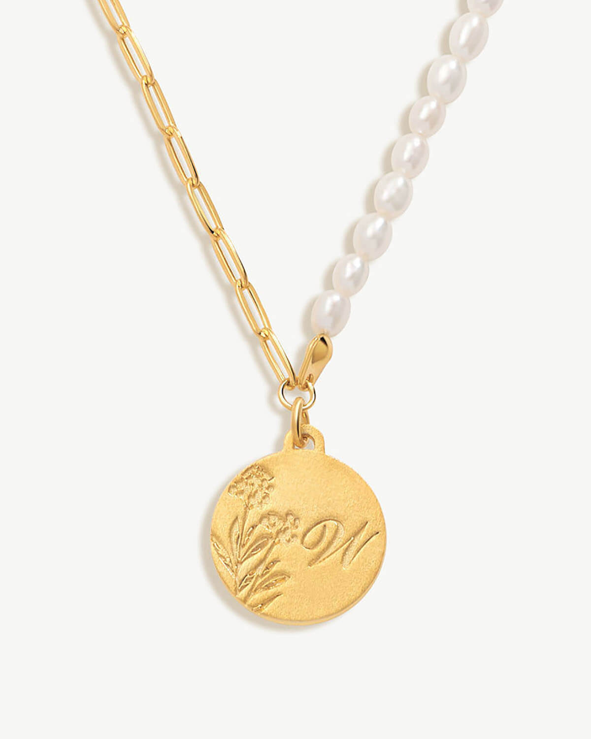 a close up of a necklace on a white background