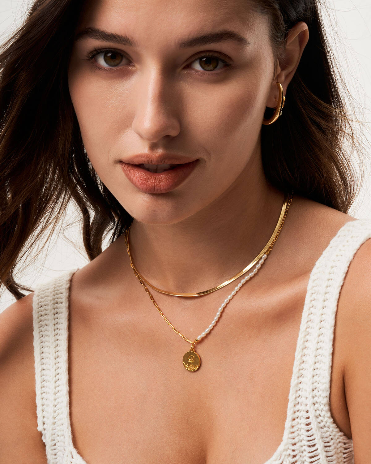 a close up of a woman wearing a necklace