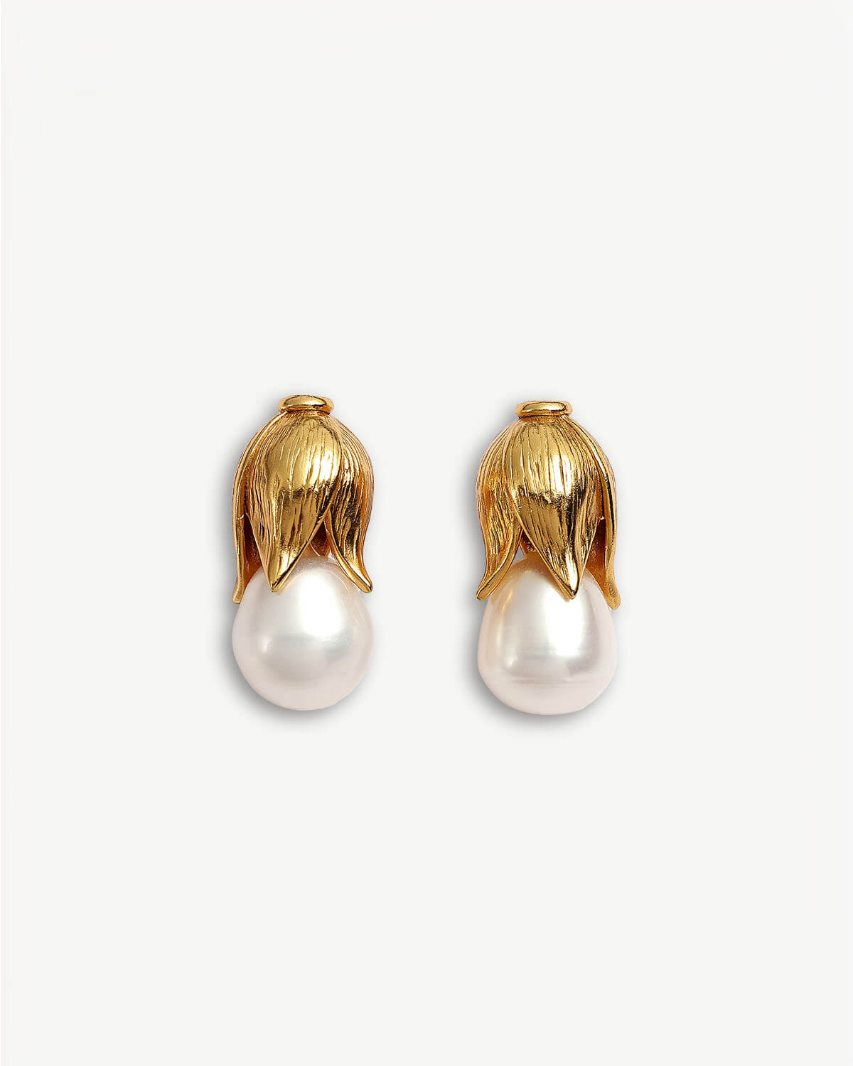 a pair of gold and pearl earrings