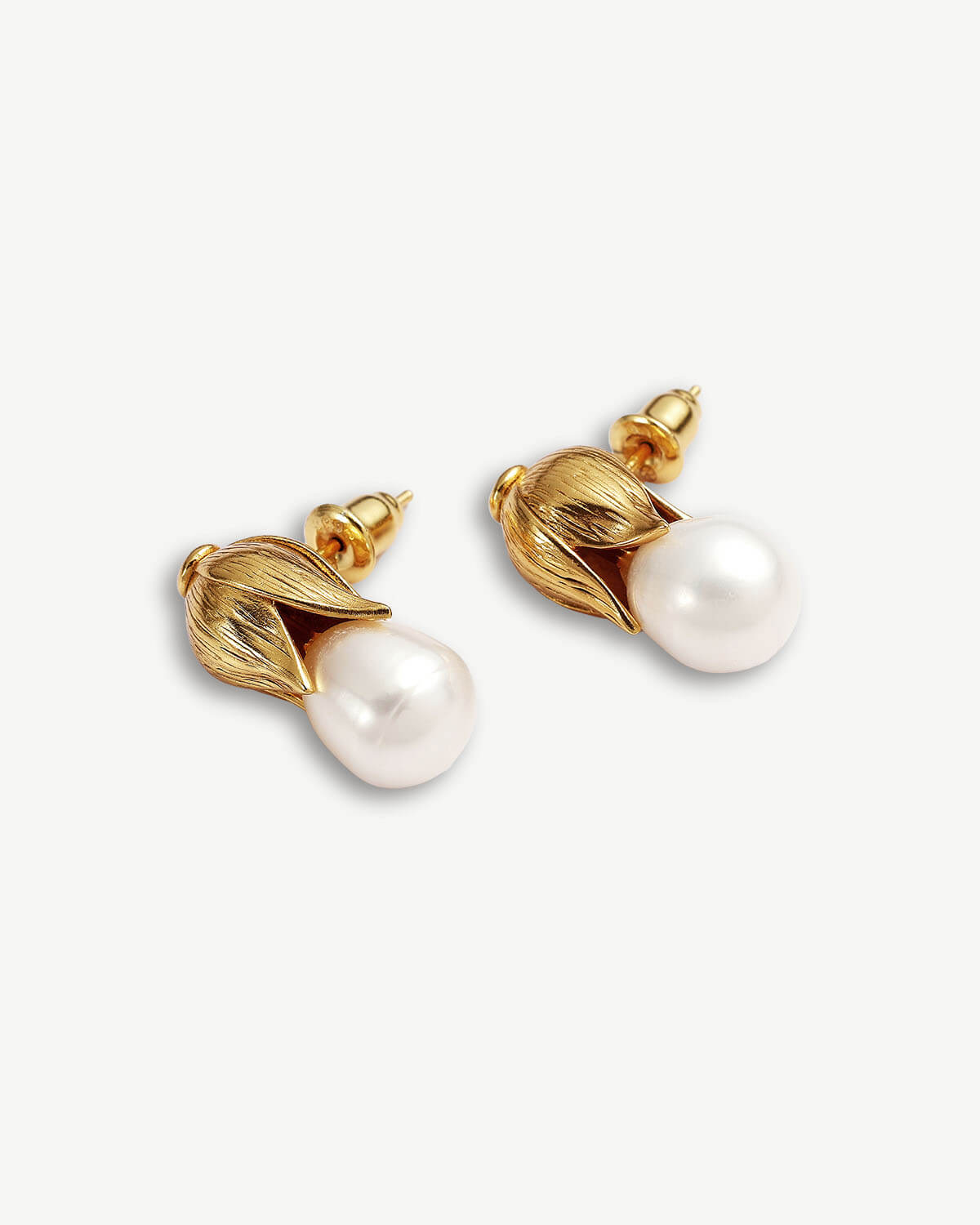 a pair of earrings with pearls on a white background