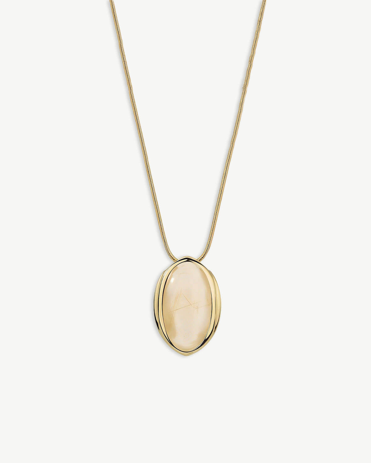 a gold necklace with a white stone in the center