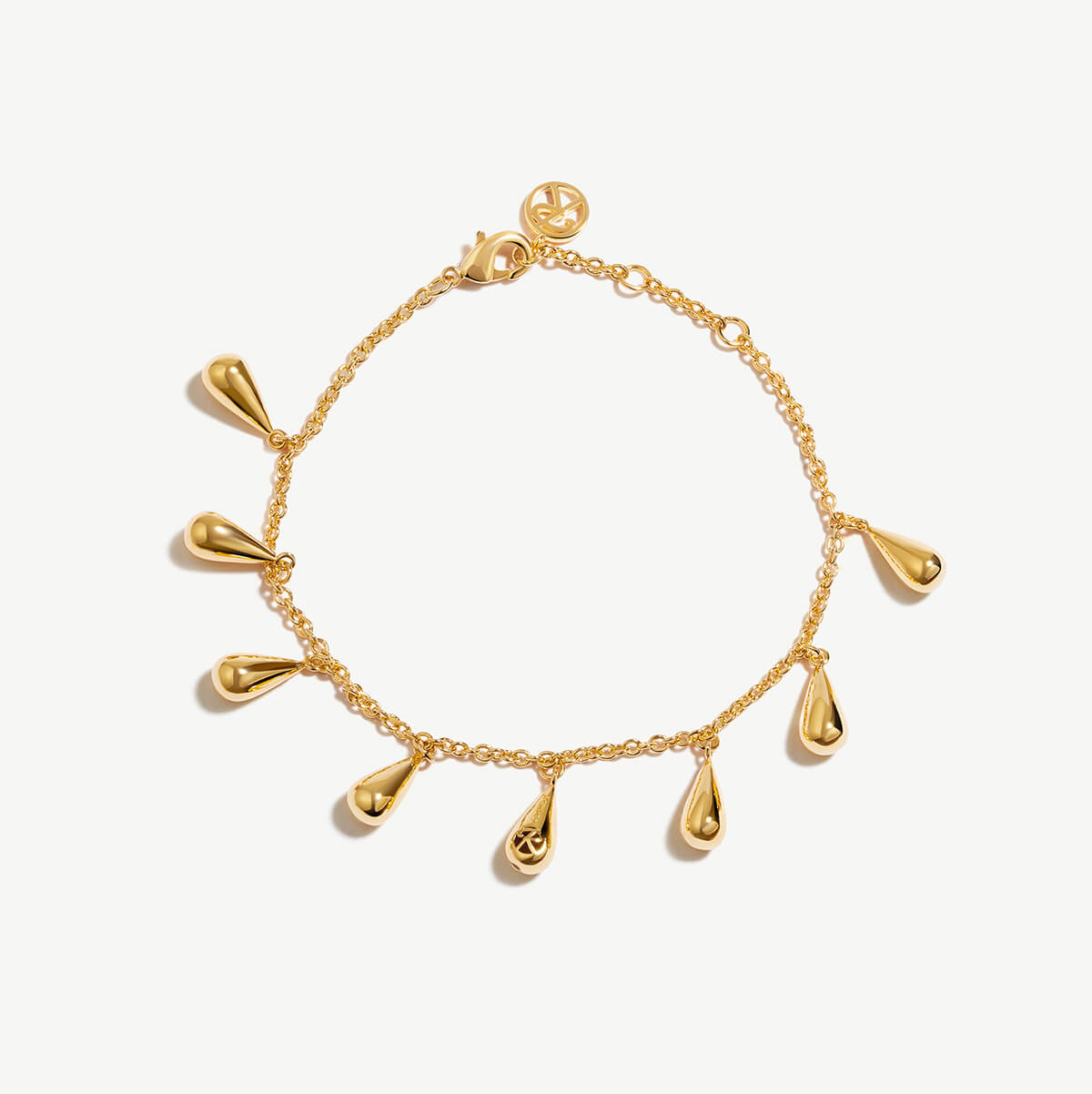 a gold bracelet with dangling drops