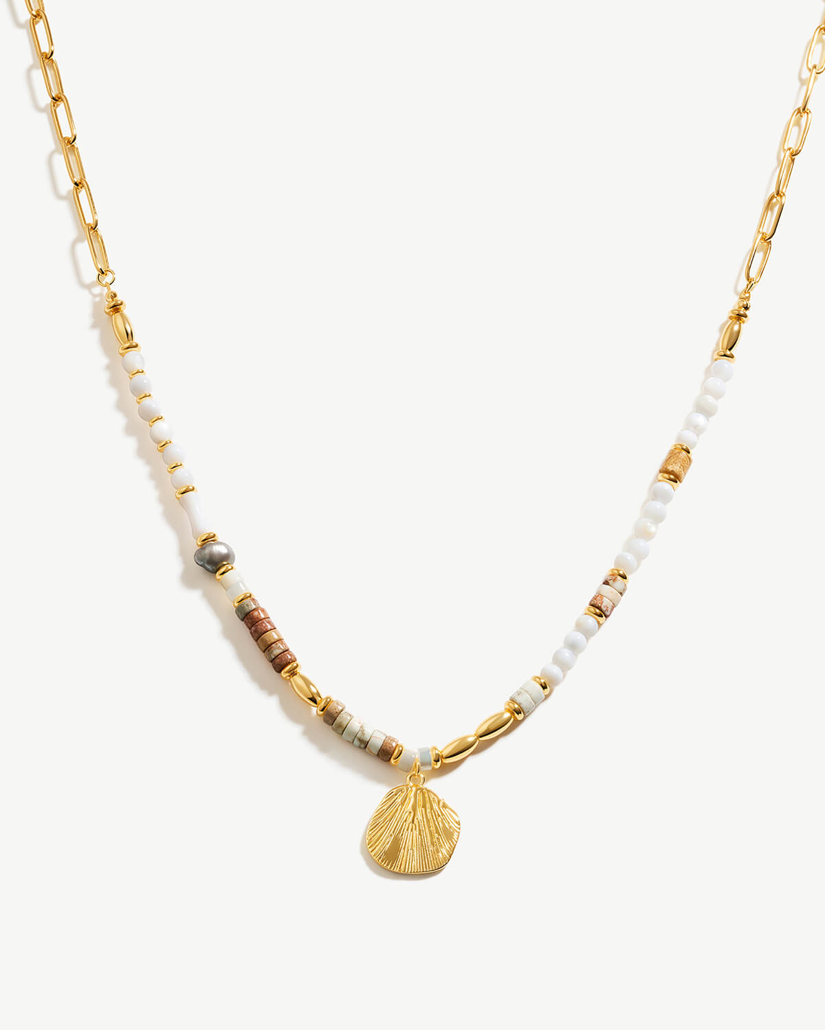 a necklace with a shell on a chain