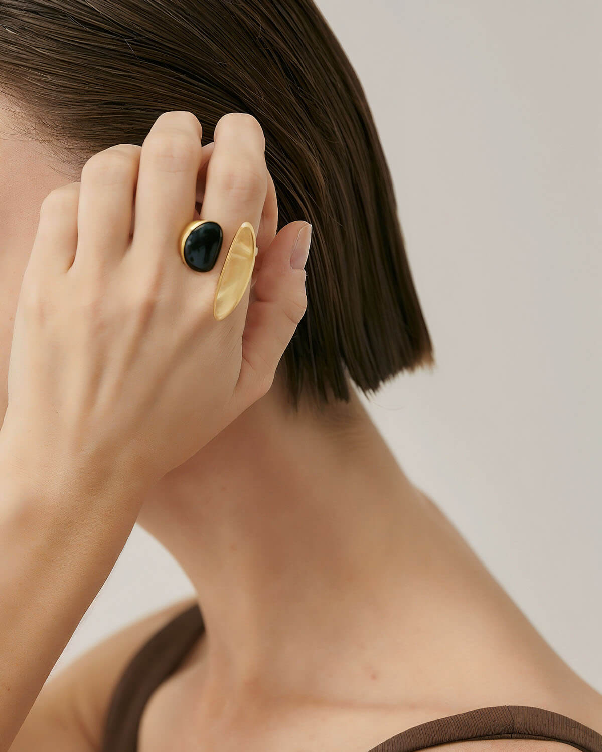 a woman holding her hand up to her face