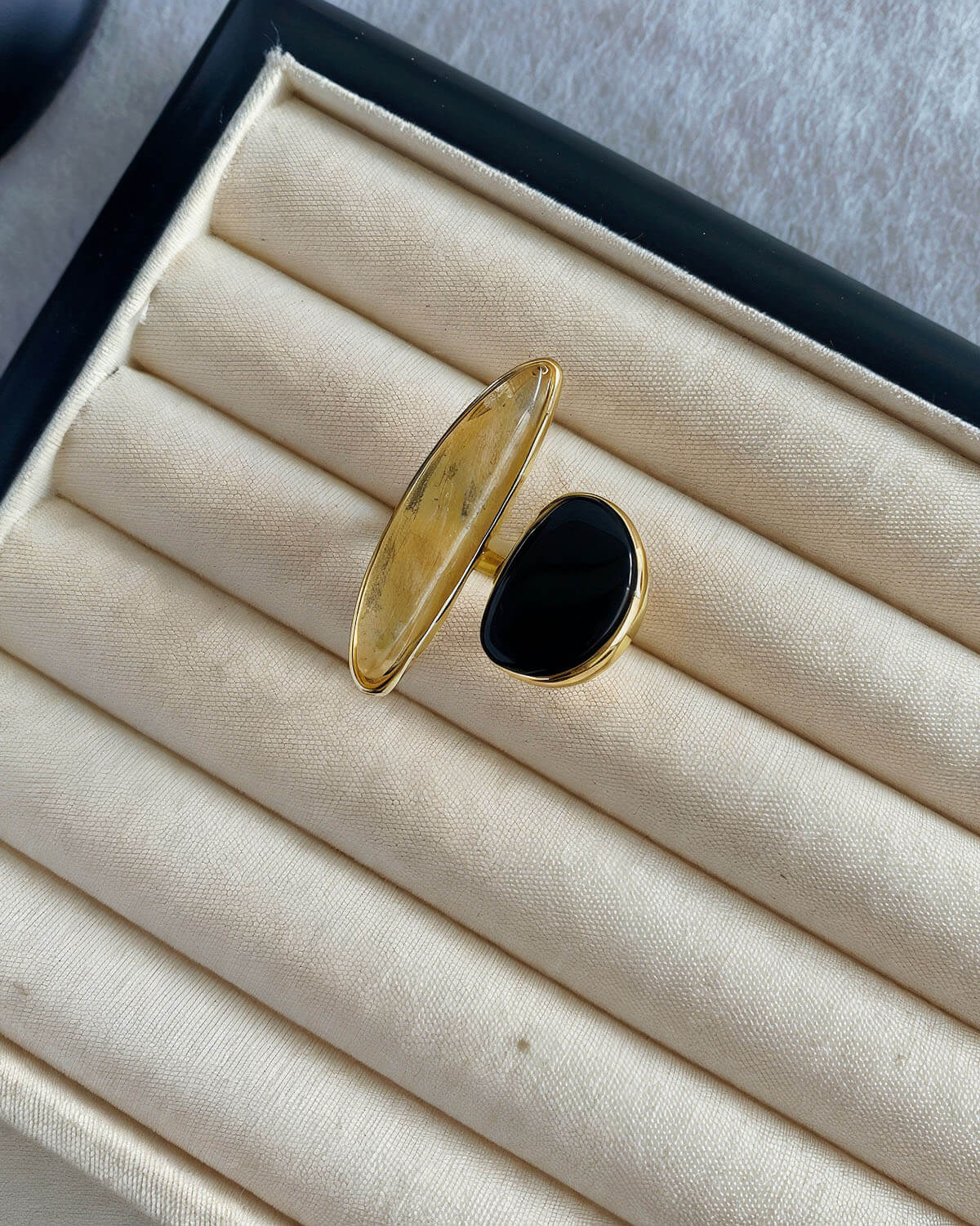 a pair of black and gold rings sitting in a box