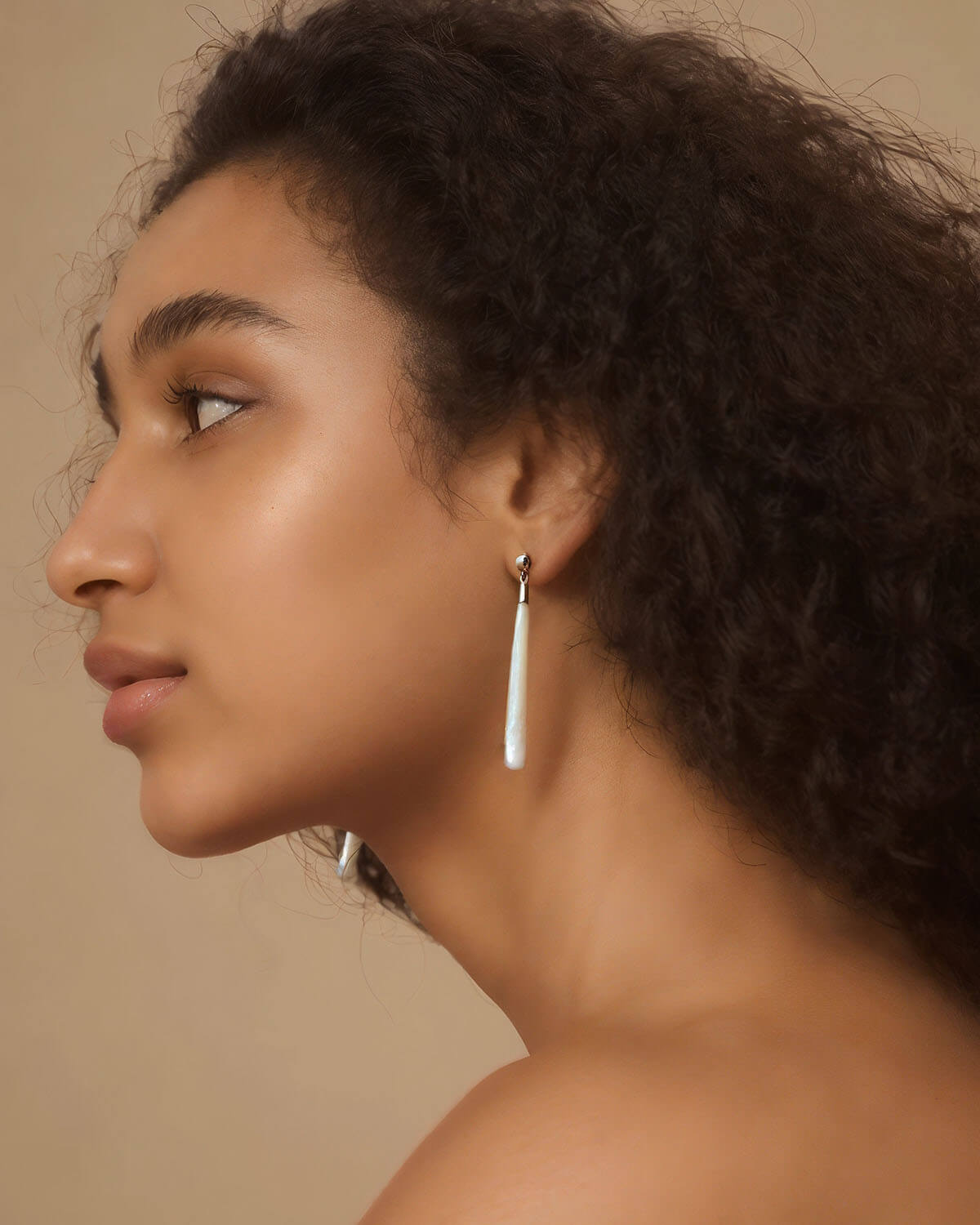 a close up of a person wearing a pair of earrings