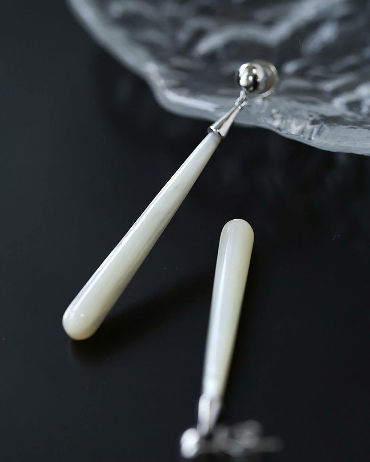 a pair of white toothbrushes sitting on top of a table