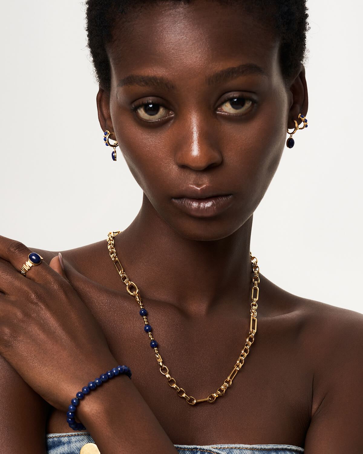 a woman with a necklace and bracelet on her neck