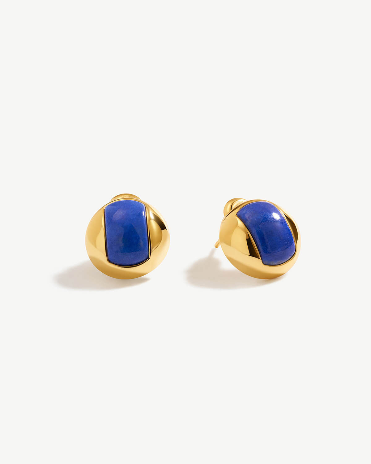 a pair of blue and gold earrings on a white background