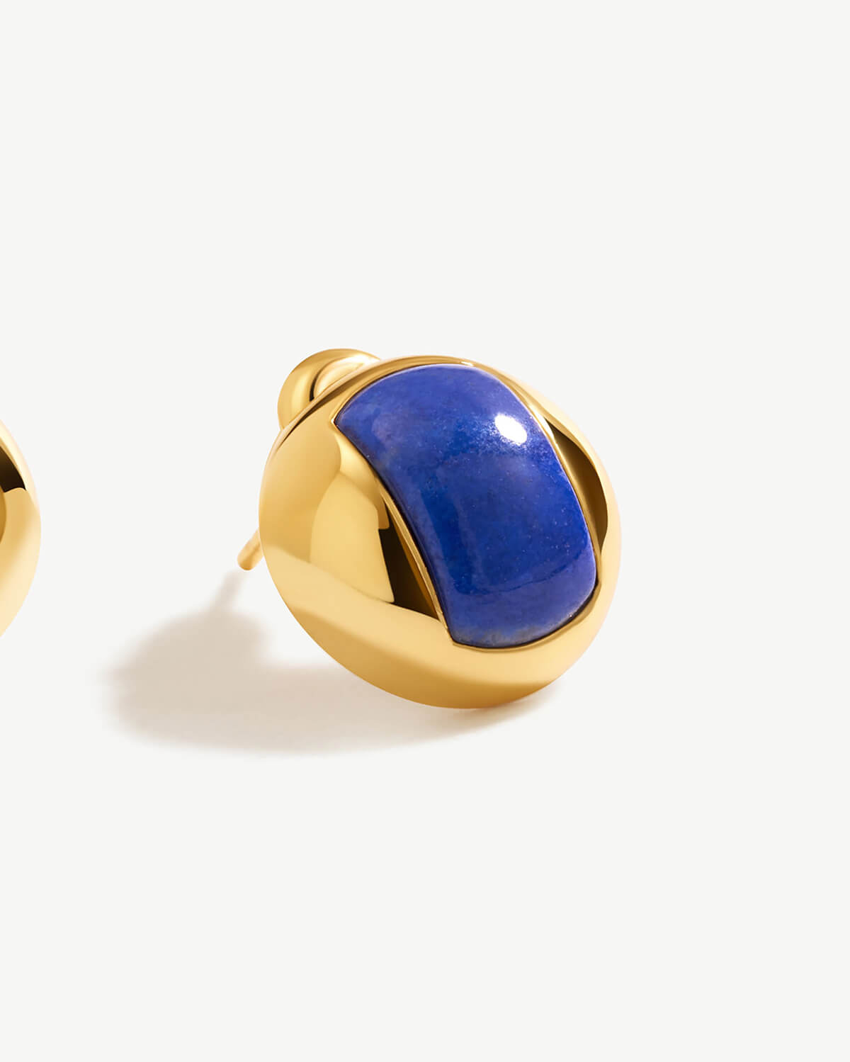 a pair of gold and lapis earrings