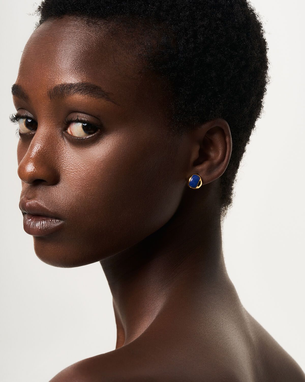 a close up of a person wearing a pair of earrings