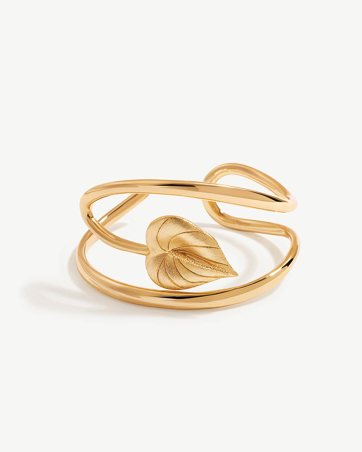 a gold ring with a leaf on it